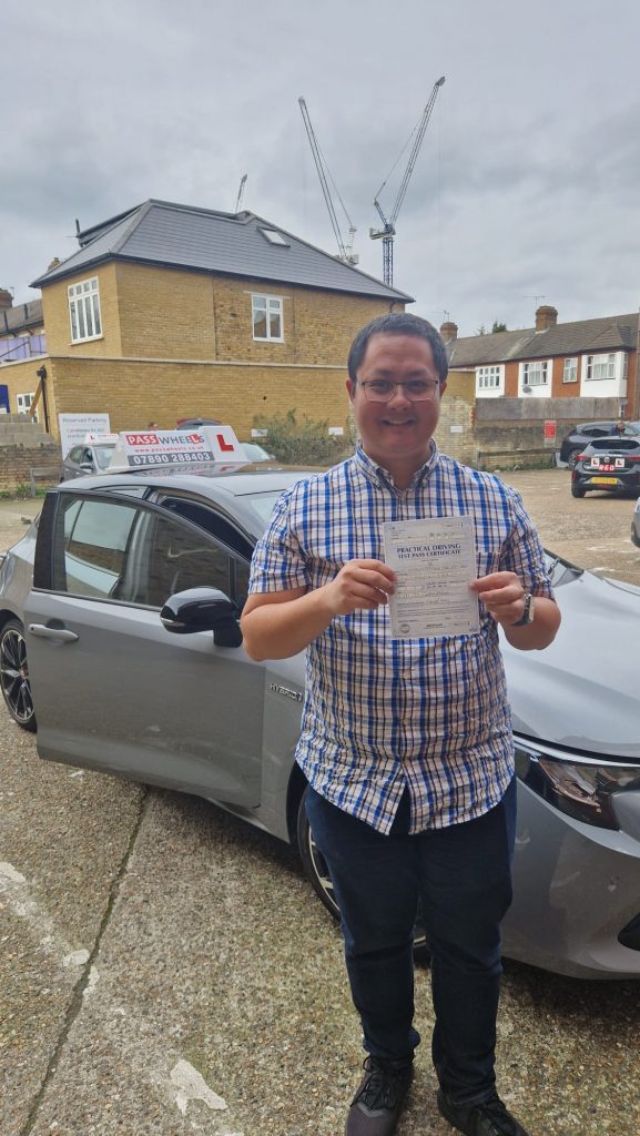 Pass Wheels pupil holding their practical driving test pass certificate