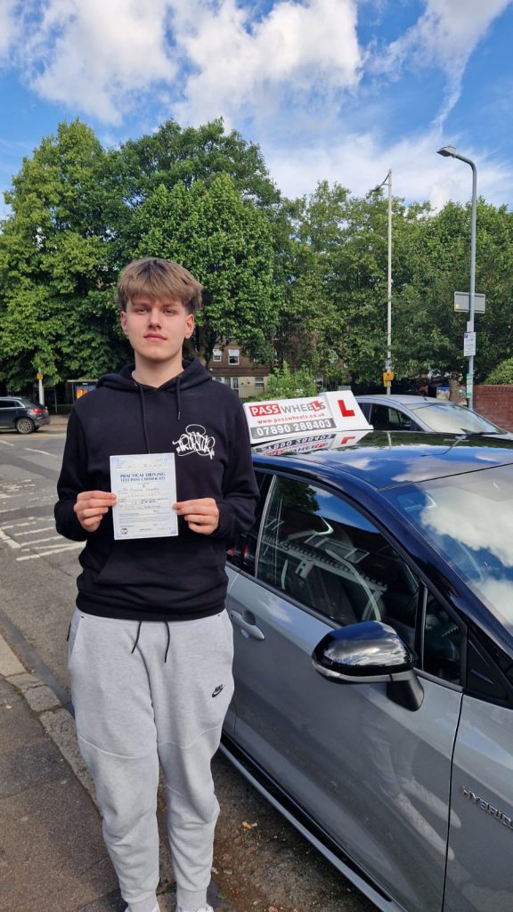 Pass Wheels pupil holding their practical driving test pass certificate