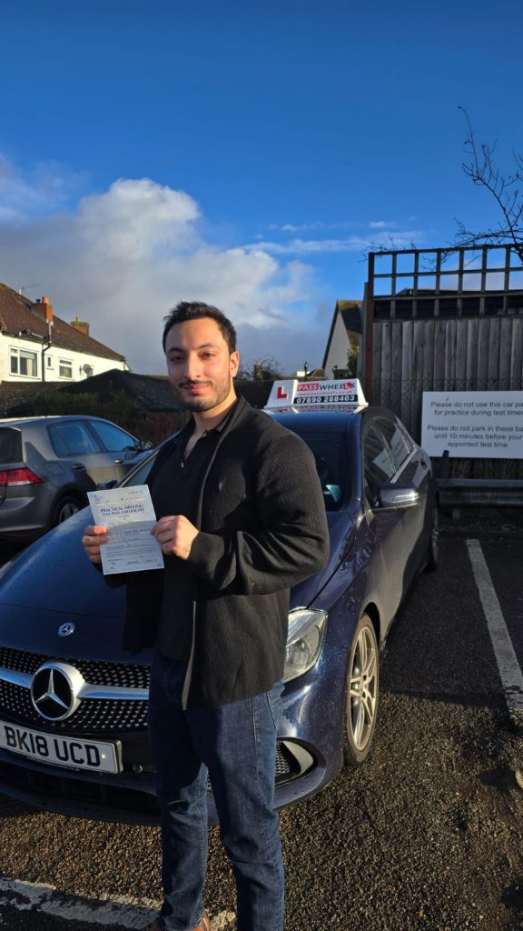 Pass Wheels pupil holding their practical driving test pass certificate