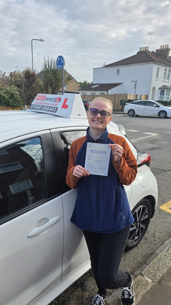 Pass Wheels pupil holding their practical driving test pass certificate