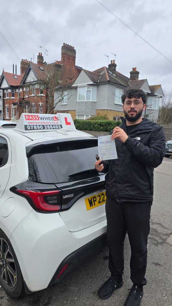 Pass Wheels pupil holding their practical driving test pass certificate