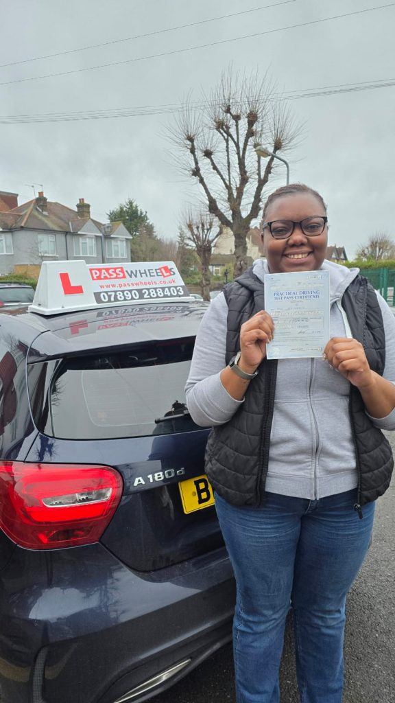 Pass Wheels pupil holding their practical driving test pass certificate