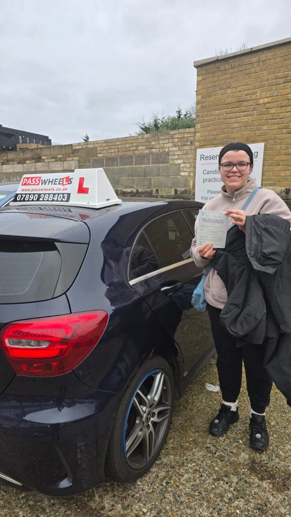Pass Wheels pupil holding their practical driving test pass certificate