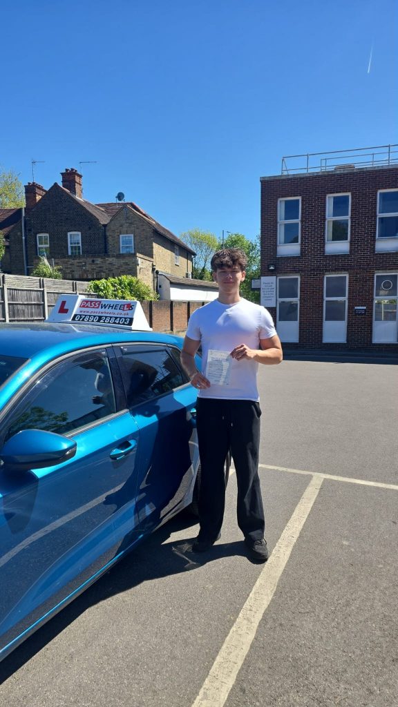 Pass Wheels pupil holding their practical driving test pass certificate