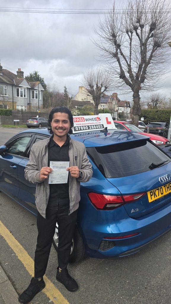 Pass Wheels pupil holding their practical driving test pass certificate